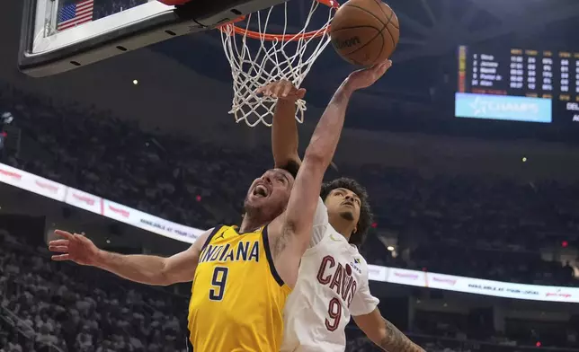 Indiana Pacers guard T.J. McConnell, left, shoots as Cleveland Cavaliers guard Craig Porter Jr. defends in the first half during Game 2 in the Eastern Conference semifinals of the NBA basketball playoffs Tuesday, May 6, 2025, in Cleveland. (AP Photo/Sue Ogrocki)