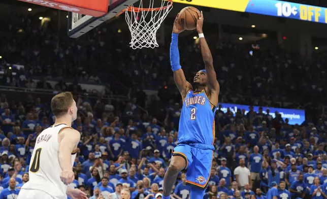 Oklahoma City Thunder's Shai Gilgeous-Alexander (2) leaps to the basket to dunk as Denver Nuggets' Christian Braun (0) defends in the second half of Game 7 in the Western Conference semifinals of the NBA basketball playoffs, Sunday, May 18, 2025, in Oklahoma City. (AP Photo/Kyle Phillips)
