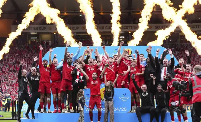 Aberdeen's team members celebrate after the Scottish Cup final soccer match between Aberdeen and Celtic at Hampden Park in Glasgow, Scotland, Saturday, May 24, 2025. (Jane Barlow/PA via AP)