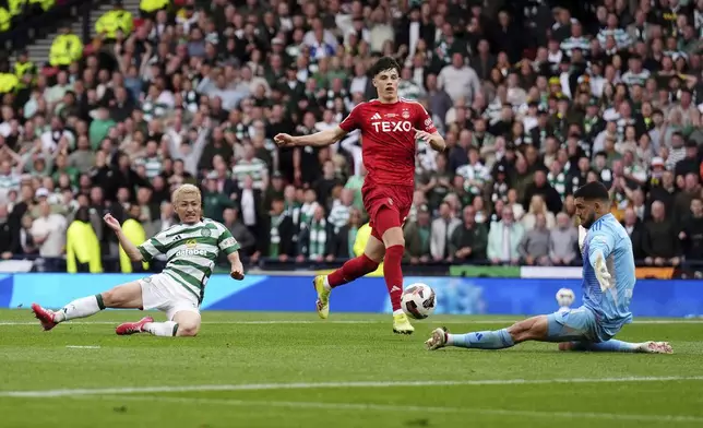 Celtic's Daizen Maeda, left, attempts a shot on goal during during the Scottish Cup final soccer match between Aberdeen and Celtic at Hampden Park in Glasgow, Scotland, Saturday, May 24, 2025. (Andrew Milligan/PA via AP)