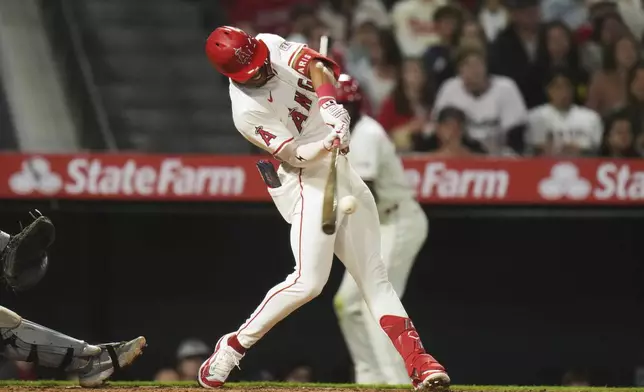 Los Angeles Angels' Kyren Paris (19) connects for a two-run single during the sixth inning of a baseball game against the Detroit Tigers Saturday, May 3, 2025, in Anaheim, Calif. (AP Photo/Jae C. Hong)
