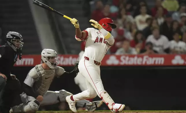 Los Angeles Angels' Luis Rengifo (2) follows through after hitting a two-RBI single during the sixth inning of a baseball game against the Detroit Tigers Saturday, May 3, 2025, in Anaheim, Calif. (AP Photo/Jae C. Hong)
