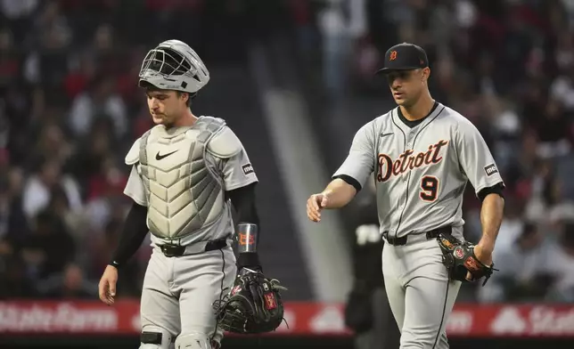 Detroit Tigers starting pitcher Jack Flaherty (9) and catcher Dillon Dingler walk toward the dugout after the third inning of a baseball game against the Los Angeles Angels Saturday, May 3, 2025, in Anaheim, Calif. (AP Photo/Jae C. Hong)