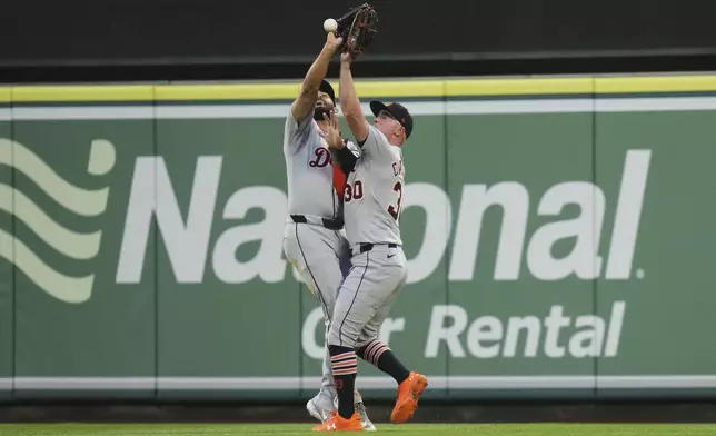 Detroit Tigers' Riley Greene (31) and Kerry Carpenter (30) collide as they try to catch a ball hit by Los Angeles Angels' Kyren Paris during the second inning of a baseball game Saturday, May 3, 2025, in Anaheim, Calif. (AP Photo/Jae C. Hong)