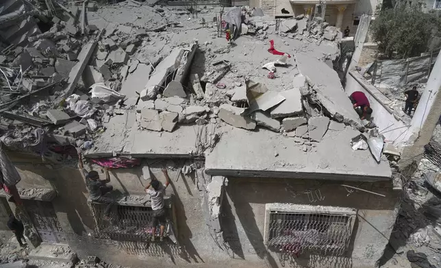 Palestinians inspect the house of the Jabr family after it was hit earlier by an Israeli army strike killing at least 10 people, in Jabalia, northern Gaza Strip, Sunday, May 18, 2025. (AP Photo/Jehad Alshrafi)