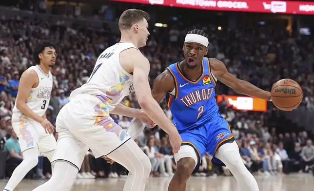 Oklahoma City Thunder guard Shai Gilgeous-Alexander, right, drives to the basket as Denver Nuggets guard Christian Braun defends in the second half of Game 6 in the Western Conference semifinals of the NBA basketball playoffs Thursday, May 15, 2025, in Denver. (AP Photo/David Zalubowski)