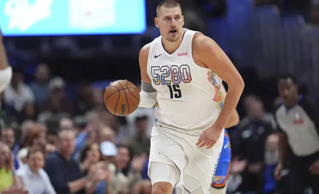 Denver Nuggets center Nikola Jokic collects a loose ball in the first half of Game 6 in the Western Conference semifinals of the NBA basketball playoffs against the Oklahoma City Thunder Thursday, May 15, 2025, in Denver. (AP Photo/David Zalubowski)