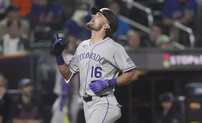 Colorado Rockies' Sam Hilliard gestures as he runs the bases after hitting a home run during the seventh inning of a baseball game against the New York Mets Friday, May 30, 2025, in New York. (AP Photo/Frank Franklin II)