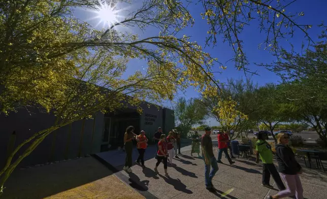 People walk in memory of loved ones during an observance of Missing &amp; Murdered Indigenous Peoples Day (MMIP) at the Indigenous Cultural Center at Scottsdale Community College, Friday, May 2, 2025, in Scottsdale, Ariz. (AP Photo/Matt York)