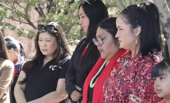 A group of women listen to a prayer before participating in a walk marking Missing and Murdered Indigenous Persons Awareness Day at the Indian Pueblo Cultural Center in Albuquerque, New Mexico, on Monday, May 5, 2025. (AP Photo/Susan Montoya Bryan)