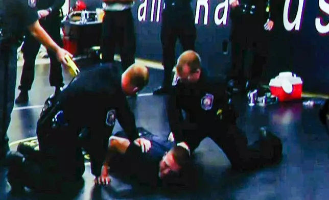 A video image provided by WOOD-TV shows former Grand Rapids Police officer Christopher Schurr being tased during his police academy training, played for the jury during testimony in the first day of Schurr's murder trial for the 2022 killing of a Black motorist, Patrick Lyoya, at the Kent County Courthouse in Grand Rapids, Mich., Monday, April 28, 2025. (WOOD-TV/Pool Photo/Kalamazoo Gazette via AP)