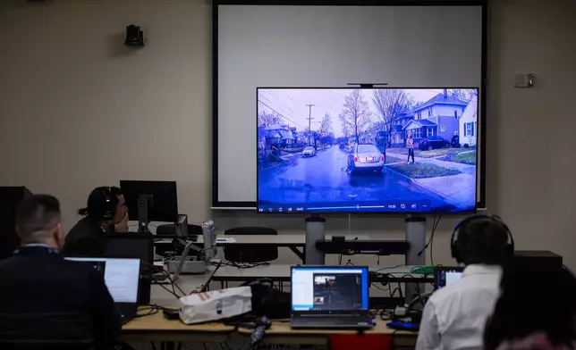 Members of the media watch as dash cam footage from former Grand Rapids Police officer Christopher Schurr patrol vehicle is played for the jury during Schurr's murder trial in the 2022 killing of a Black motorist, Patrick Lyoya, at Kent County Courthouse in Grand Rapids, Mich., Monday, April 28, 2025. (Joel Bissell/MLive.com/Kalamazoo Gazette via AP)