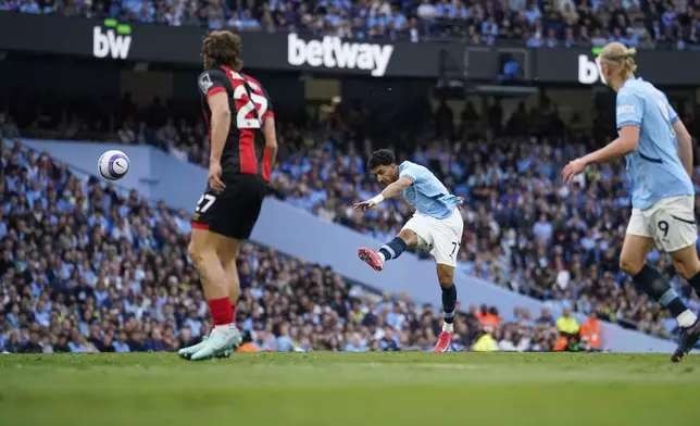 Manchester City's Omar Marmoush scores his side's opening goal during the English Premier League soccer match between Manchester City and Bournemouth at the Etihad stadium in Manchester, England, Tuesday, May 20, 2025. (AP Photo/Dave Thompson)