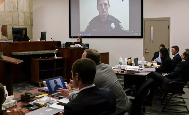 A video image provided by WOOD-TV of former Grand Rapids police officer Christopher Schurr taken by Jessica Beaudry, crime scene technician with Grand Rapids Police Department, is displayed on the first day of Schurr's trial, who is charged in the 2022 killing of a Black motorist, Patrick Lyoya, at the Kent County Courthouse, Monday, April 28, 2025, Grand Rapids, Mich. (WOOD-TV/Pool Photo/Kalamazoo Gazette via AP)