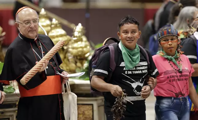 FILE - Cardinal Pedro Ricardo Barreto, left, attends the opening prayer for the Amazon synod, in St. Peter's Basilica at the Vatican, Monday, Oct. 7, 2019. (AP Photo/Andrew Medichini, File)