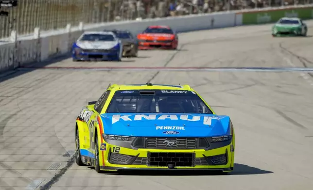 Ryan Blaney (12) heads into Turn 1 during a NASCAR Cup Series auto race at Texas Motor Speedway in Fort Worth, Texas, Sunday, May 4, 2025. (AP Photo/Larry Papke)