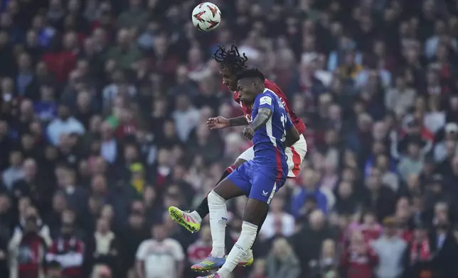 Manchester United's Leny Yoro, background, and Athletic Bilbao's Alvaro Djalo challenge for the ball during the Europa League semifinal second leg soccer match between Manchester United and Athletic Bilbao in Manchester, Britain, Thursday, May 8, 2025. (AP Photo/Dave Thompson )