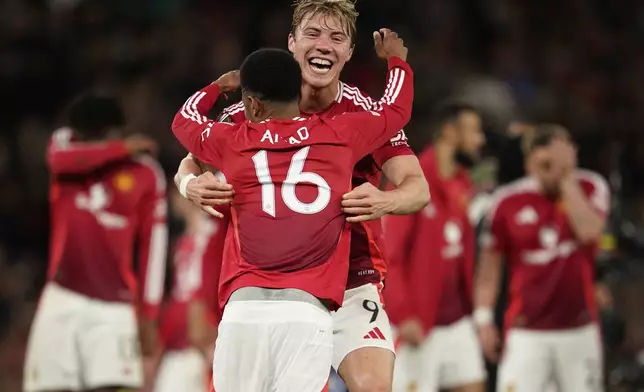 Manchester United's Rasmus Hojlund, background, and Amad Diallo celebrate after during the Europa League semifinal second leg soccer match between Manchester United and Athletic Bilbao in Manchester, Britain, Thursday, May 8, 2025. (AP Photo/Dave Thompson)