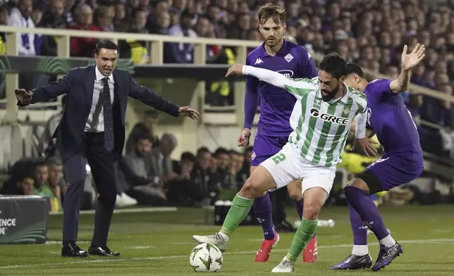 Betis' Isco shields the ball from Fiorentina's Rolan Mandragora during the UEFA Conference League second leg semifinal soccer match between Fiorentina and Real Betis at Artemio Franchi stadium in Florence, Italy, Thursday, May 8, 2025. (Marco Bucco/LaPresse via AP)