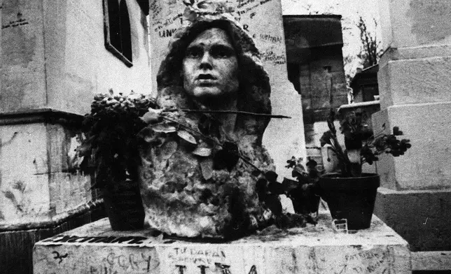 FILE- This Sept. 7, 1971 file photo shows the grave of Jim Morrison, lead singer of the rock group "The Doors," at the Pere Lachaise cemetery in Paris, France. (AP Photo/Joe Marquette,File)