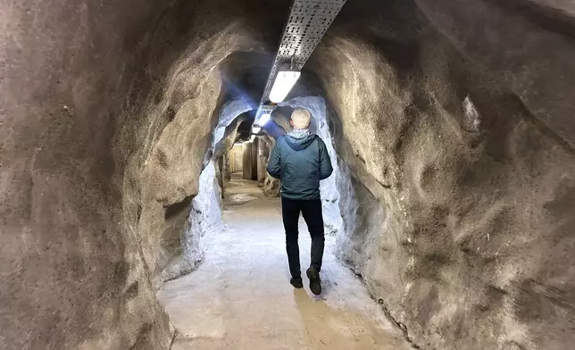 Odd John Resser, Emergency Planning Officer for the municipality, walks in the tunnel of a Cold War era underground shelter which was dusted off after Russia's invasion of Ukraine, in Kongsberg, Norway Thursday, May 8, 2025. (AP Photo/Emma Burrows)