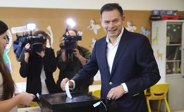 Incumbent Prime Minister and leader of the center-right Social Democratic Party Luis Montenegro casts his ballot in Portugal's general election at polling station in Espinho, Portugal, Sunday, May 18, 2025. (AP Photo/Luis Vieira)
