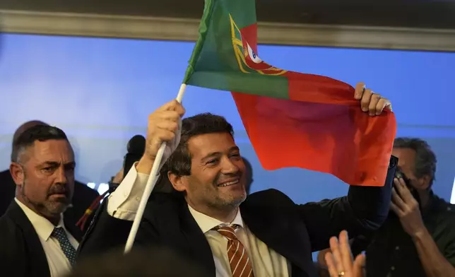 "The hard-right populist party Chega" leader Andre Ventura holds a Portugal's flag following Portugal's general election, in Lisbon, Monday, May 19, 2025. (AP Photo/Ana Brigida)