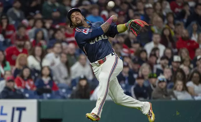 Cleveland Guardians' Jose Ramirez throws to first base but not in time to put out Los Angeles Angels' Logan O'Hoppe during the seventh inning of a baseball game, Friday, May 30, 2025, in Cleveland. (AP Photo/Phil Long)