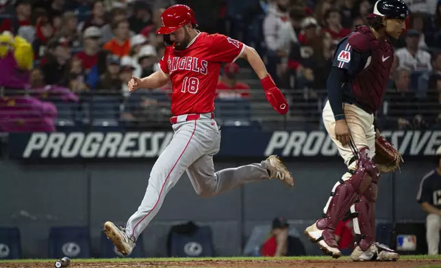 Los Angeles Angels' Nolan Schanuel scores on an RBI single by Jorge Soler as Cleveland Guardians' Bo Naylor stands by during the seventh inning of a baseball game, Friday, May 30, 2025, in Cleveland. (AP Photo/Phil Long)