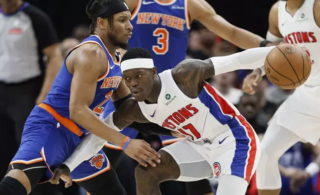 Detroit Pistons guard Dennis Schroder (17) drives against New York Knicks guard Miles McBride (2) during the first half of Game 6 of an NBA basketball first-round playoff series Thursday, May 1, 2025, in Detroit. (AP Photo/Duane Burleson)