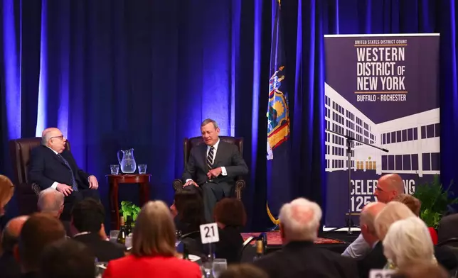 Chief Justice John Roberts, right, speaks with U.S. District Judge Lawrence J. Vilardo during a fireside chat at the 125th anniversary celebration of the United States District court for the Western District of New York, Wednesday, May 7, 2025, in Buffalo, N.Y. (AP Photo/Jeffrey T. Barnes