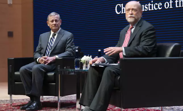 Georgetown Law Dean William Treanor, right, introduces U.S. Supreme Court Chief Justice John Roberts during a lecture to the Georgetown Law School graduating class of 2025, in Washington, Monday, May 12, 2025. (AP Photo/Manuel Balce Ceneta)