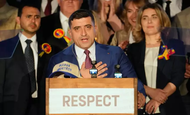 Presidential candidate George Simion speaks to media after polls closed for the second round of the country's presidential election redo in Bucharest, Romania, Sunday, May 18, 2025. (AP Photo/Vadim Ghirda)