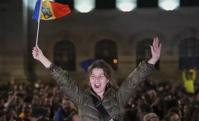 Supporters of Presidential candidate Nicusor Dan celebrate on the street after polls closed for the second round of the country's presidential election redo in Bucharest, Romania, Monday, May 19, 2025. (AP Photo/Andreea Alexandru)