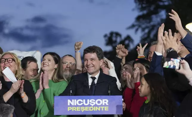 Presidential candidate Nicusor Dan speaks to media after polls closed for the second round of the country's presidential election redo in Bucharest, Romania, Sunday, May 18, 2025. (AP Photo/Andreea Alexandru)