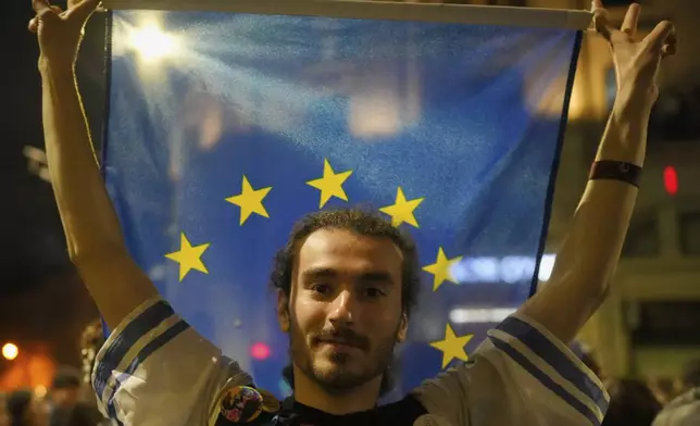 Supporters of Presidential candidate Nicusor Dan celebrate on the street after polls closed for the second round of the country's presidential election redo in Bucharest, Romania, Monday, May 19, 2025. (AP Photo/Andreea Alexandru)