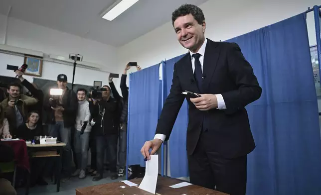 Presidential candidate Nicusor Dan casts his vote in the second round of the country's presidential election redo in Fagaras, Romania, Sunday, May 18, 2025. (AP Photo/Alex Nicodim)