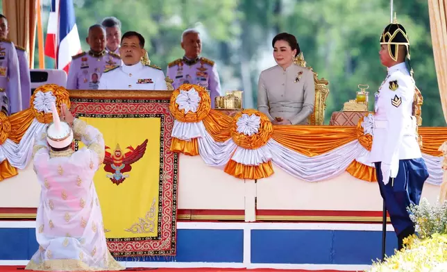 Thai master of the plowing ceremony, Prayoon Inskul, bottom left, prays for Thailand's King Maha Vajiralongkorn, center left, and Queen Suthida before the start of a royal plowing ceremony in Bangkok, Thailand, Friday, May 9, 2025. (Sunti Teapia/Pool Photo via AP)