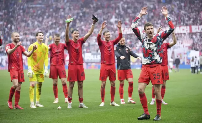 Bayern players thank the fans at the end of the German Bundesliga soccer match between RB Leipzig and FC Bayern Munich at the Red Bull Arena in Leipzig, Germany, Saturday, May 3, 2025. (AP Photo/Ebrahim Noroozi)