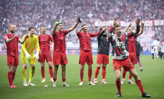 Bayern players thank the fans at the end of the German Bundesliga soccer match between RB Leipzig and FC Bayern Munich at the Red Bull Arena in Leipzig, Germany, Saturday, May 3, 2025. (AP Photo/Ebrahim Noroozi)