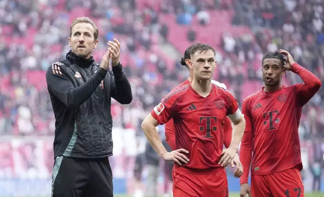 Bayern's Harry Kane, left, applauds supporters at the end of the German Bundesliga soccer match between RB Leipzig and FC Bayern Munich at the Red Bull Arena in Leipzig, Germany, Saturday, May 3, 2025. (AP Photo/Ebrahim Noroozi)