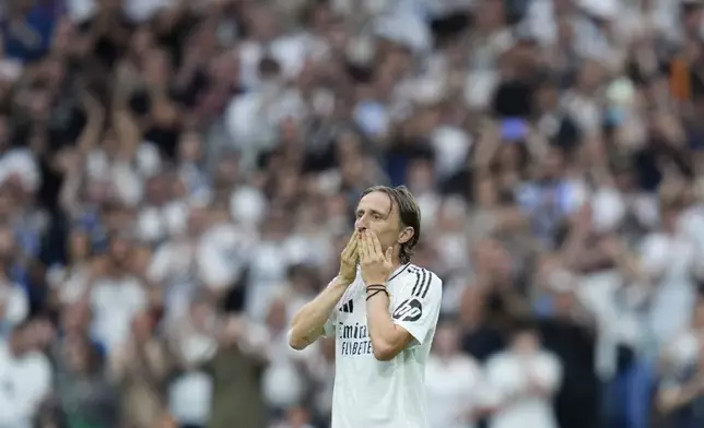 Real Madrid's Luka Modric waves to the crow during a Spanish La Liga soccer match against Real Sociedad at Santiago Bernabeu stadium in Madrid, Saturday, May 24, 2025. (AP Photo/Cesar Cebolla)