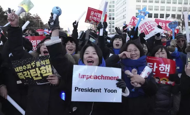 FILE - Participants react after hearing the news that South Korea's parliament voted to impeach President Yoon Suk Yeol outside the National Assembly in Seoul, South Korea, on Dec. 14, 2024. (AP Photo/Lee Jin-man, File)
