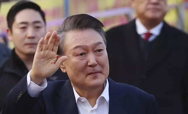 FILE - Impeached South Korean President Yoon Suk Yeol greets his supporters as he comes out of a detention center in Uiwang, South Korea, on March 8, 2025. (Kim Do-hun/Yonhap via AP, File)