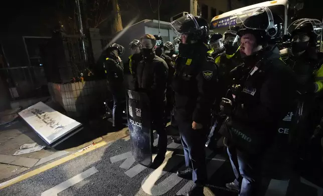 FILE - Police officers stand outside of the Seoul Western District Court after supporters of impeached South Korean President Yoon Suk Yeol broke into the court in Seoul, South Korea on Jan. 19, 2025. (AP Photo/Ahn Young-joon, File)