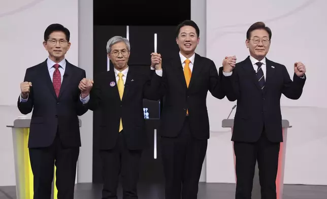 FILE - From left, South Korea's presidential candidates, Kim Moon Soo of the People Power Party, Kwon Young-guk of the Democratic Labor Party, Lee Jun-seok of the New Reform Party and Lee Jae-myung of the Democratic Party pose for photograph ahead of a televised presidential debate for the upcoming June 3 presidential election at SBS studio in Seoul, on May 18, 2025. (Chung Sung-Jun/Pool Photo via AP, File)