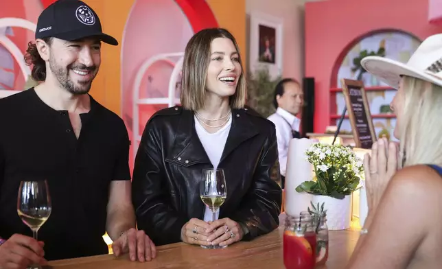Prophet and Poet winemaker Jesse Katz, left, and owner Jessica Biel pour wine in the Platinum Lounge during the first day of BottleRock at the Napa Valley Expo in Napa, California Friday, May 23, 2025. (Jessica Christian/San Francisco Chronicle via AP)
