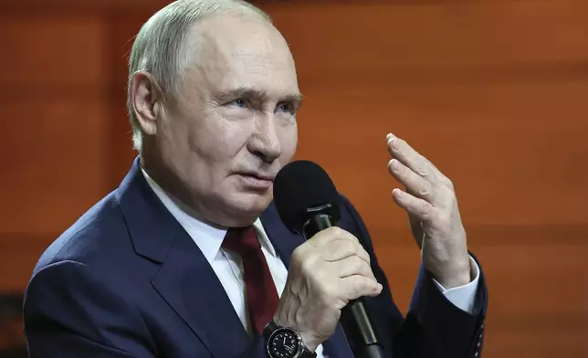 Russian President Vladimir Putin gestures while speaking to students and teachers of the new Secondary Special Music School at the Sirius Park of Science and Art after his phone talk with U.S. President Donald Trump, outside Sochi, Russia, on Monday, May 19, 2025. (Alexander Kazakov, Sputnik, Kremlin Pool Photo via AP)