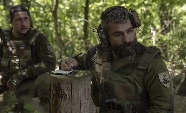 A Ukrainian serviceman of the 127th Territorial Defence Brigade prepares to fire KS-19 100mm gun towards Russian positions near Kharkiv, Ukraine, Friday, May 16, 2025. (AP Photo/Yevhen Titov)