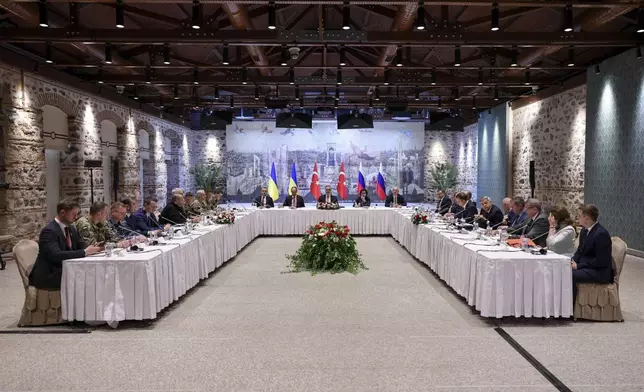 In this handout photo released by Turkish Foreign Ministry, Turkish Foreign Minister Hakan Fidan, center, chairs a meeting between delegations from Russia, right, and Ukraine, left, at Dolmabahce palace in Istanbul, Turkey, Friday, May 16, 2025. (Murat Gok/Turkish Foreign Ministry via AP)
